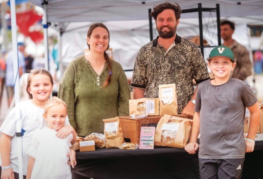 The Carlin family together behind their market table